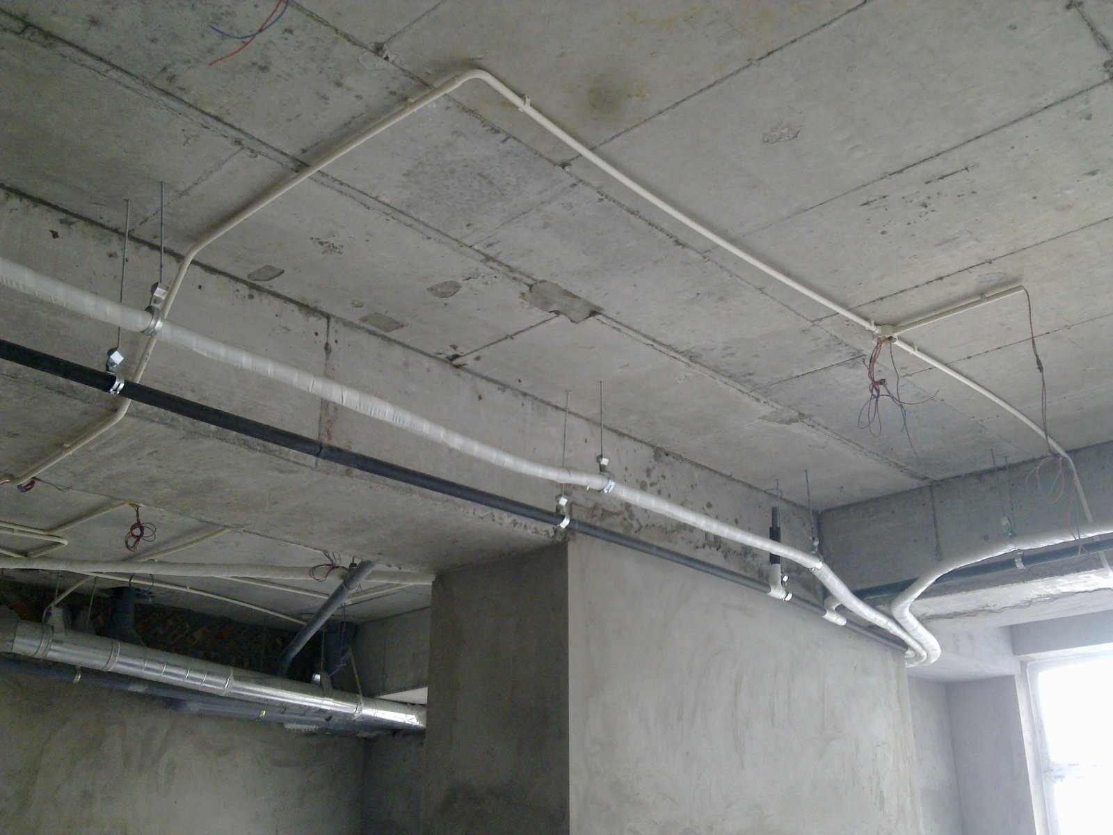 Hệ ống điện và ống nước lắp dưới sàn bê tông khi chưa đóng trần, dây chờ còn để lộ