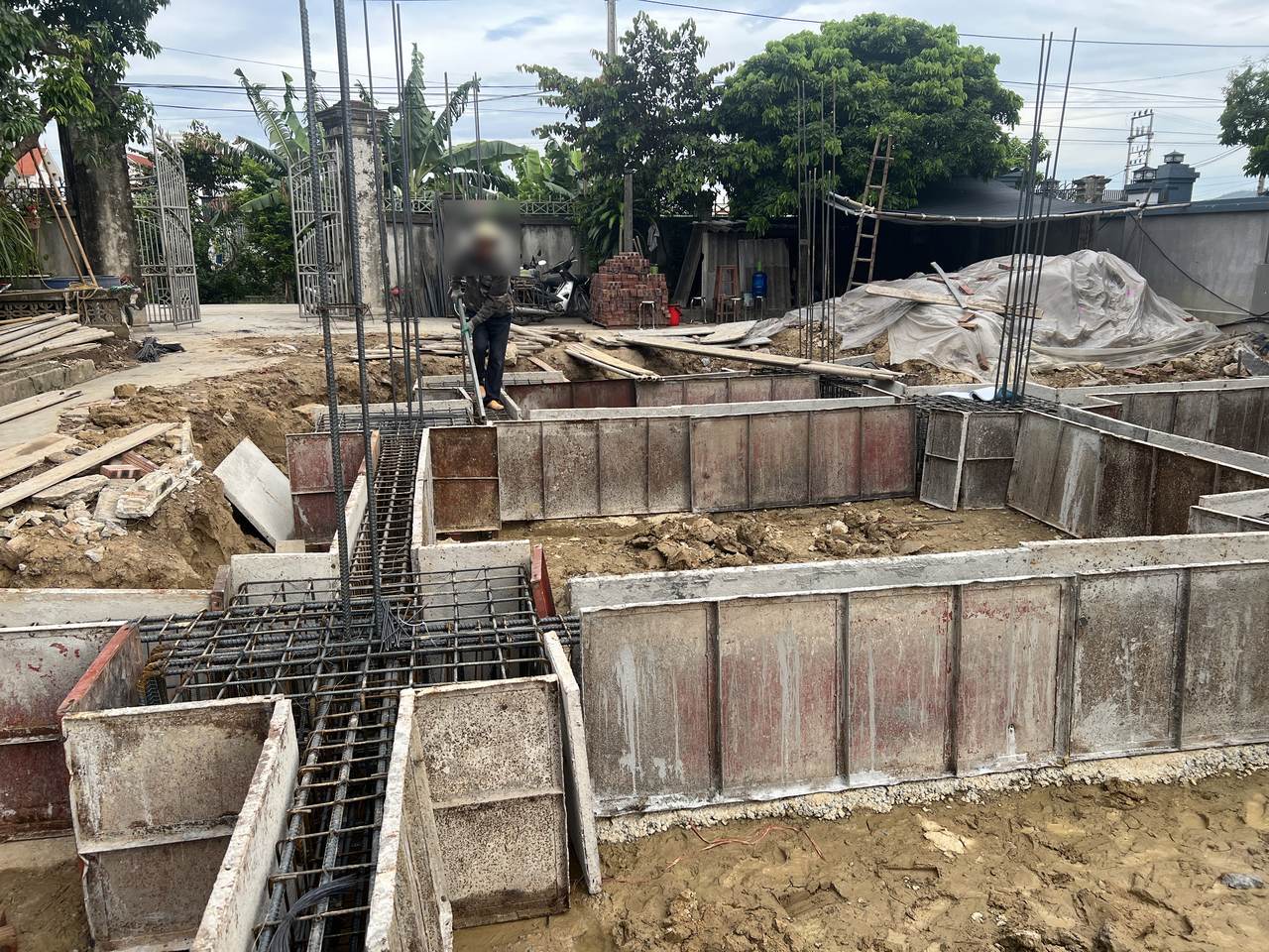 Cốp pha thép định hình của giằng móng nhà dân đã ghép, nối vào hộp cốp pha đài có thép chờ cột, trước khi đổ bê tông